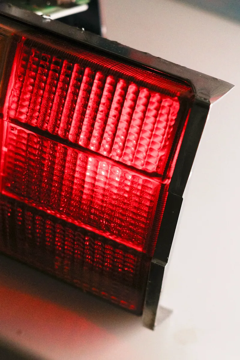 Close-up of the lit red lens of the tail light